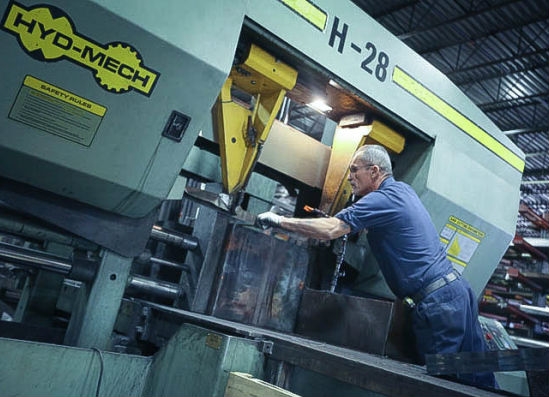 Metal Finishing Expert Adjusting CNC Machine